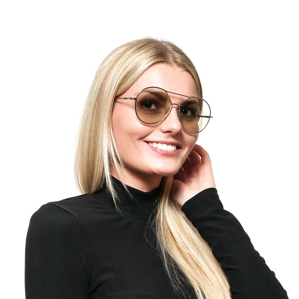 Woman wearing Web Gold metal frame butterfly sunglasses with green mirrored lenses, offering 100% UVA & UVB protection, stylish and modern.