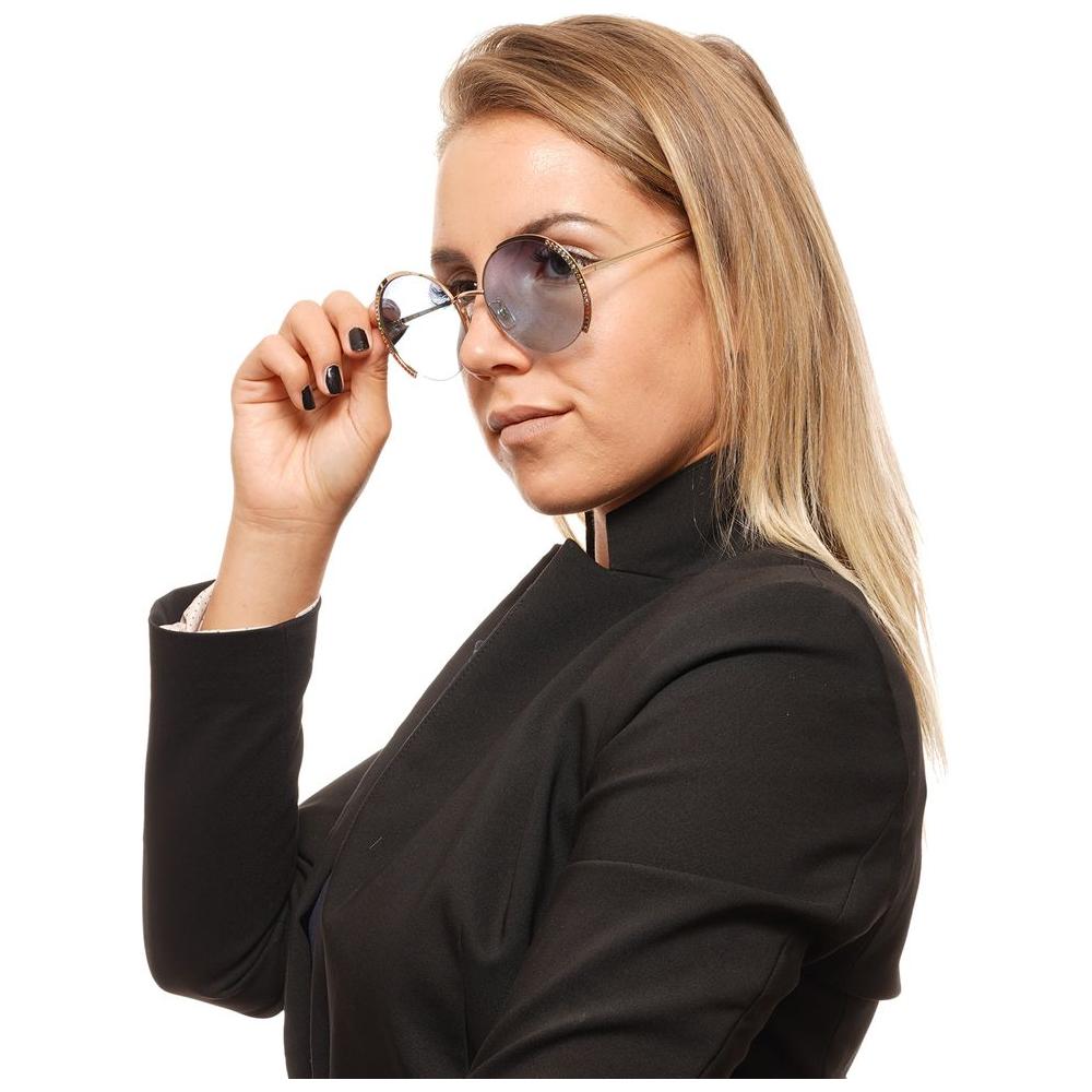 Woman wearing Swarovski gold round half-rim sunglasses with blue lenses and metal frame.