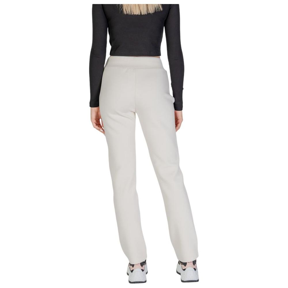 Back view of Guess Active Cream Cotton Jeans showcasing modern straight leg design and comfortable fit for women’s casual or gym wear.