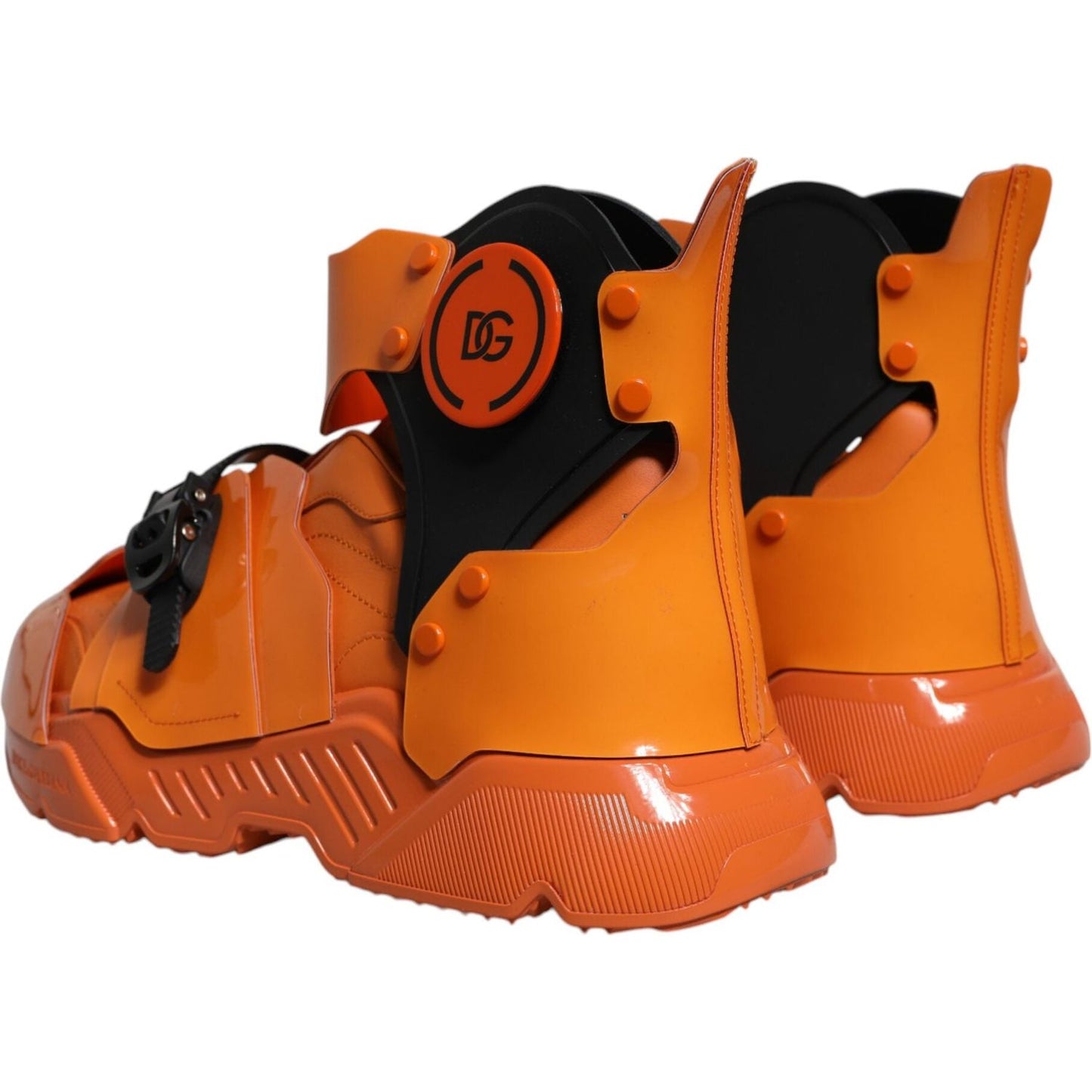 Dolce & Gabbana orange multi-panel chunky high top sneakers with logo, buckle closure, and ridged rubber sole, rear view.