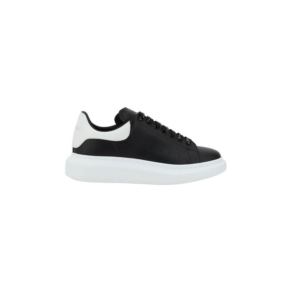 Alexander McQueen black and white leather sneakers with lace-up closure and platform sole, showcasing contemporary and elegant design.