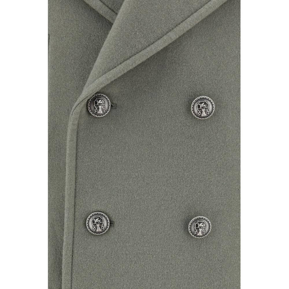 Close-up of Brunello Cucinelli wool coat featuring double-breasted closure with contrasting buttons and spear lapels.