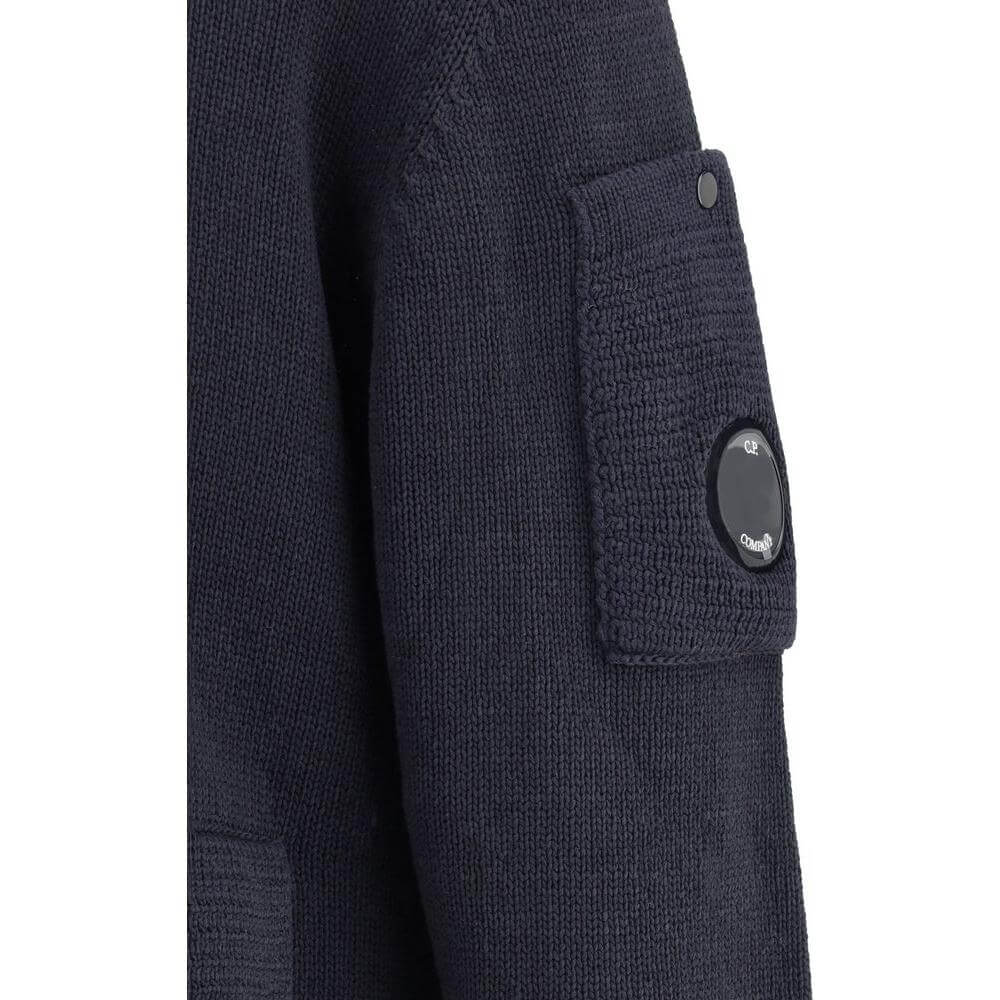 C.P. Company cotton cardigan with ribbed texture and distinctive logo detail on sleeve pocket, showcasing a functional and stylish design.