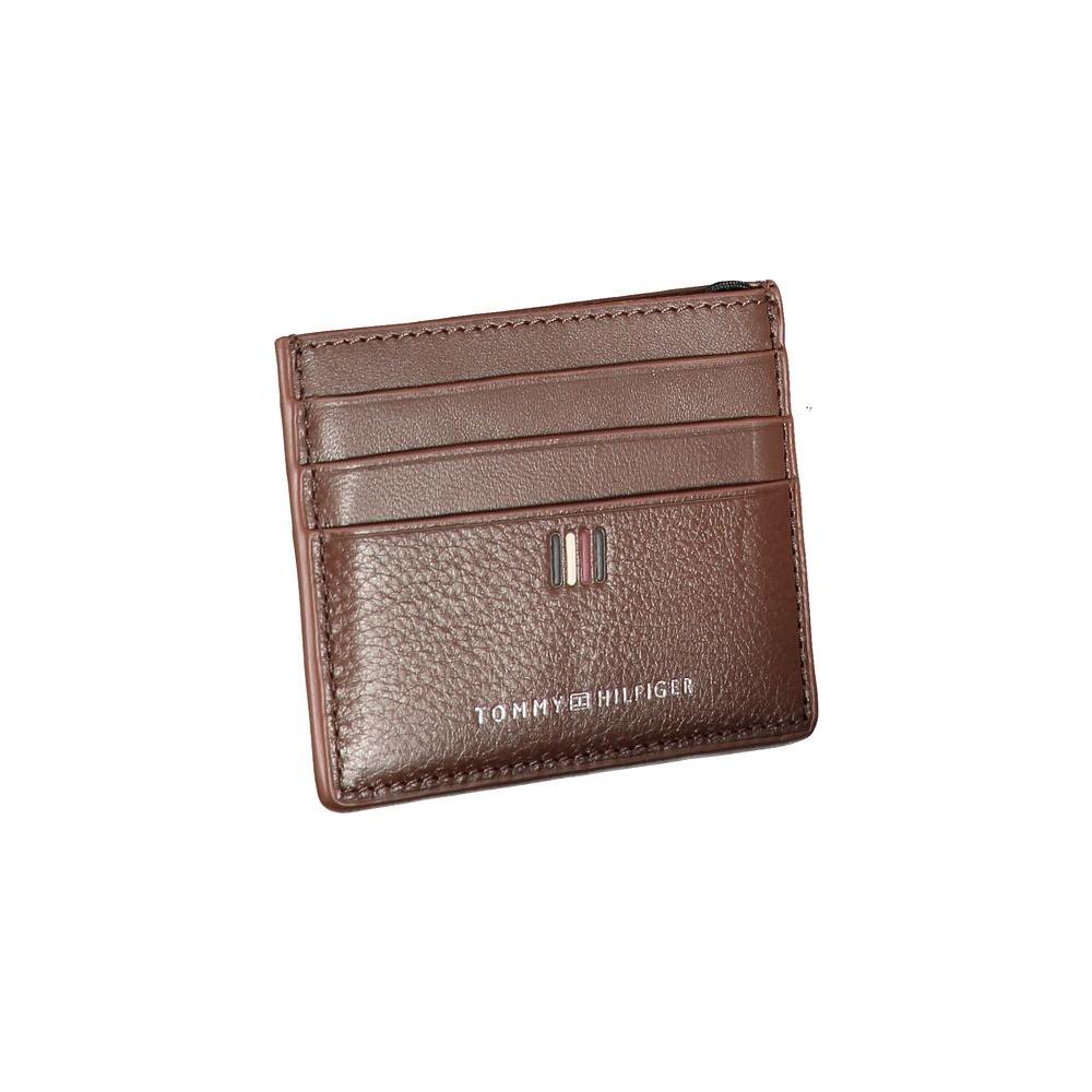 Tommy Hilfiger sleek brown leather card holder with contrast detailing, featuring embossed logo and central pocket for cards.