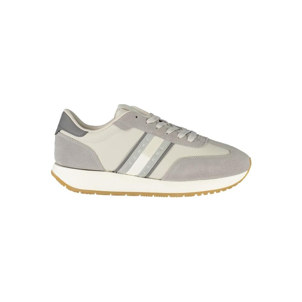 Tommy Hilfiger gray leather men's sneaker with contrasting details and lace-up design for style and comfort.