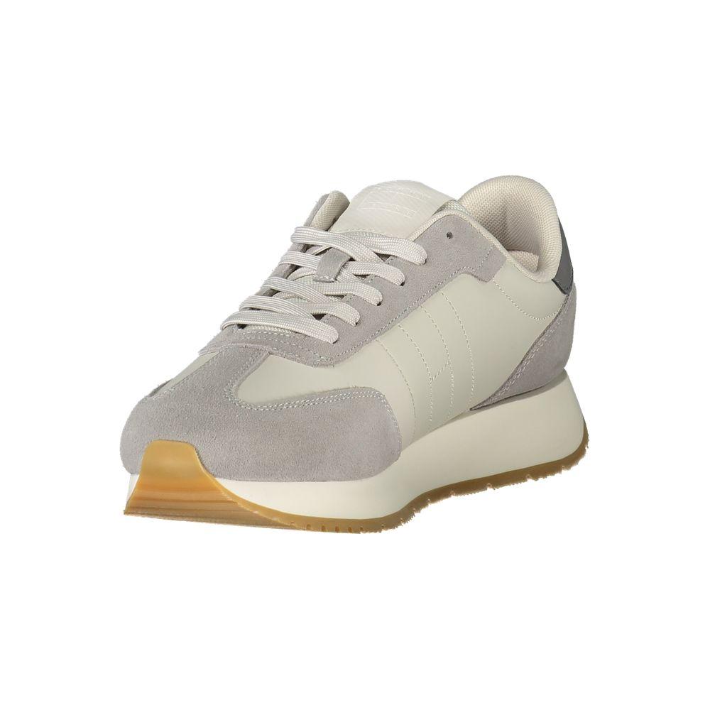 Tommy Hilfiger gray leather men's sneaker with lace-up design and contrasting details, featuring comfort and iconic logo branding.