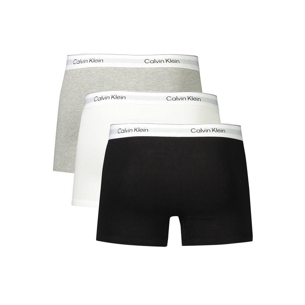 Calvin Klein men's boxers in black, grey, and white with logo waistband, crafted from cotton and elastane for comfort and style.