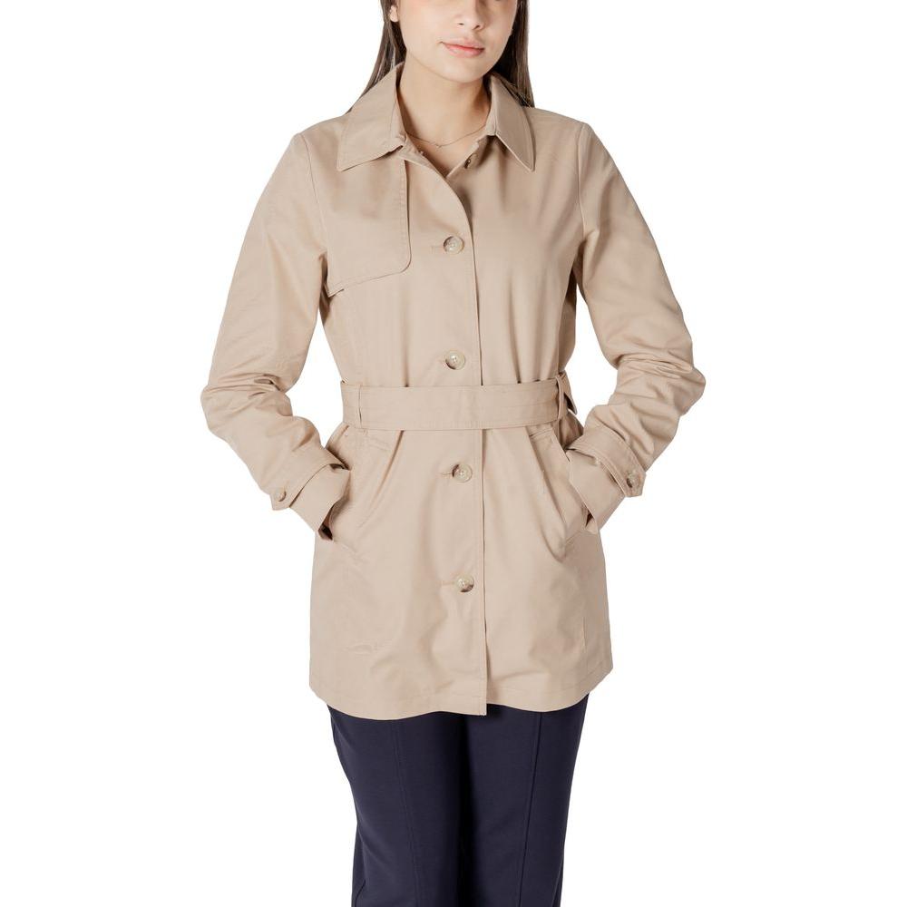 Alt Tag: Woman wearing a Street One beige cotton mid-length trench coat with buttons and belt, ideal for transitional seasons.