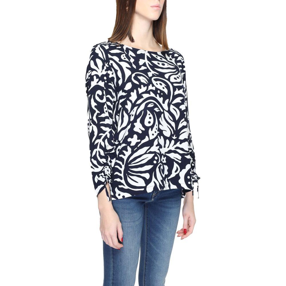 Woman wearing a blue Street One viscose shirt with an abstract pattern, long sleeves, paired with jeans; women's fashion blouse.