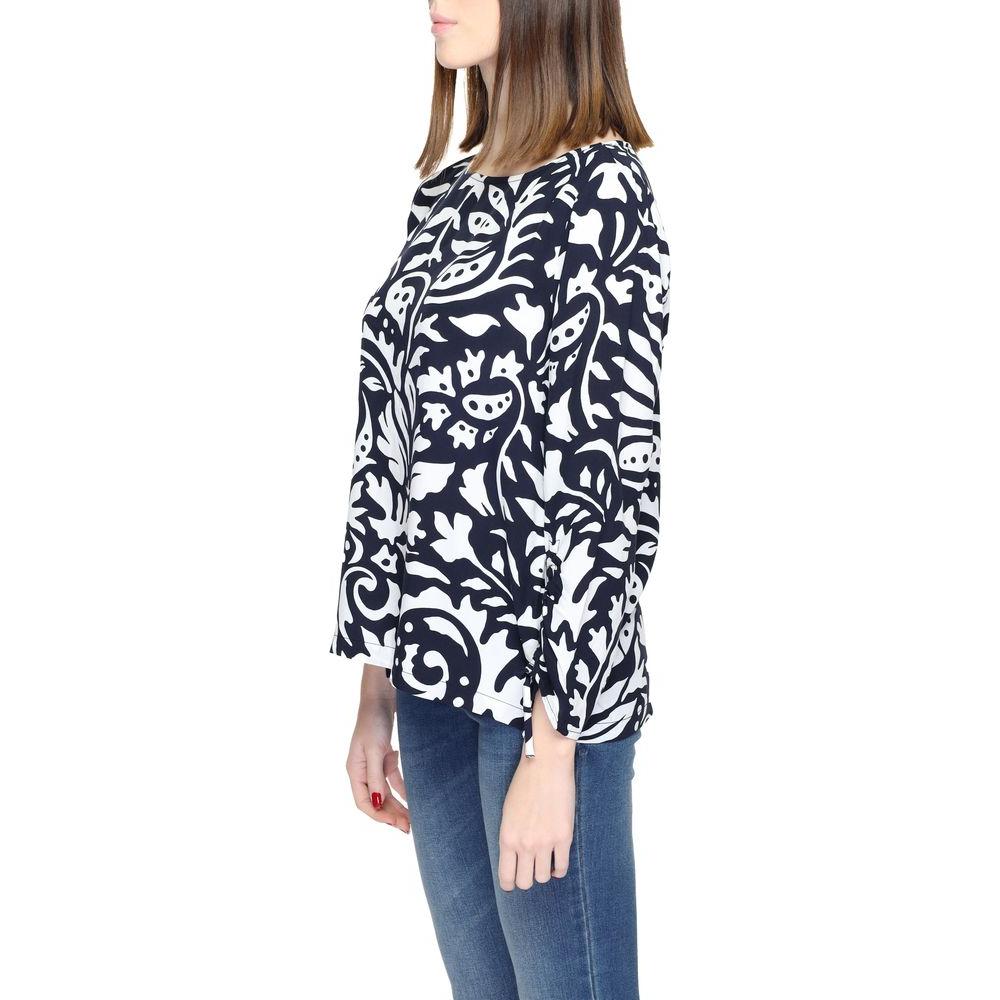 Woman wearing a long sleeve blue and white patterned blouse with jeans, showcasing Side Profile of a casual outfit.