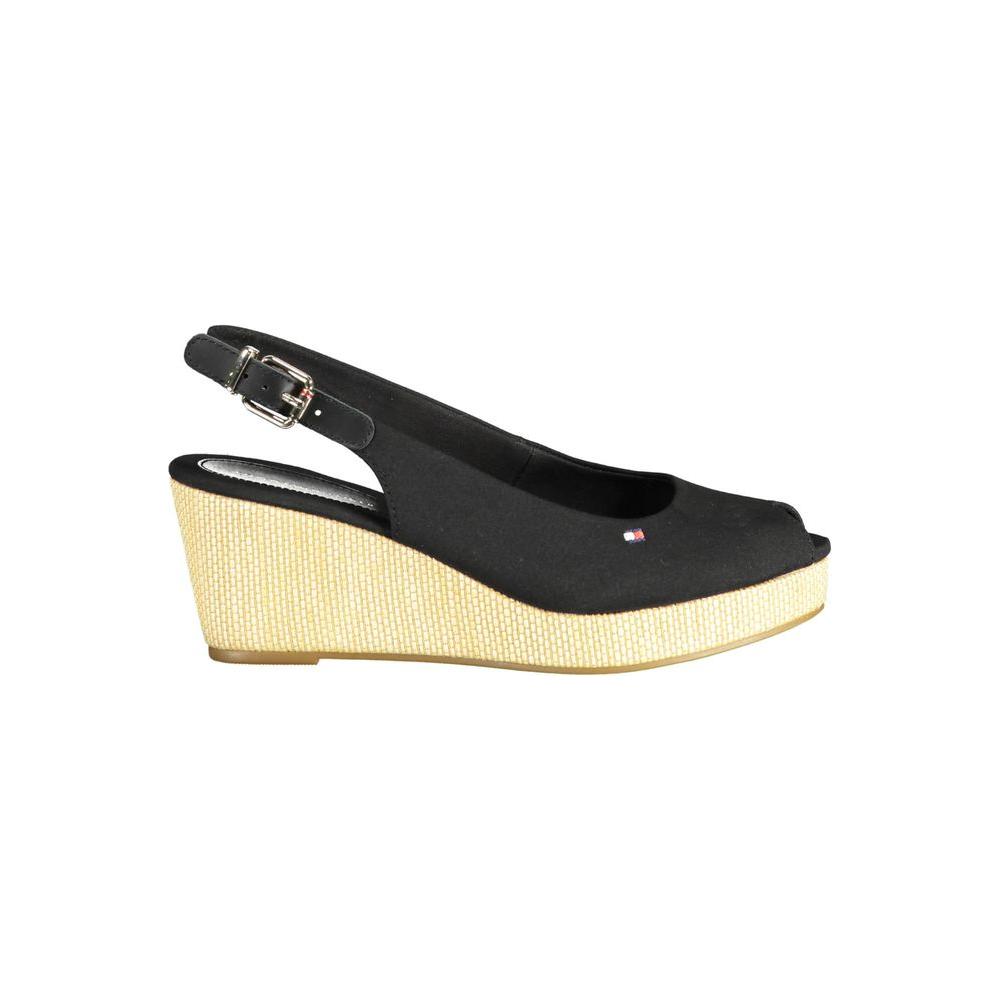 Tommy Hilfiger black leather women's sandal with sleek ankle buckle and 7 cm heel, featuring iconic logo and elegant design.