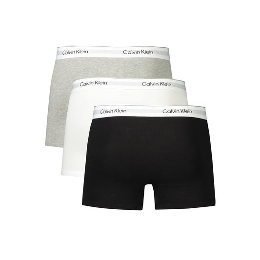 Calvin Klein men's boxers in black, grey, and white with logo waistband, crafted from cotton and elastane for comfort and style.